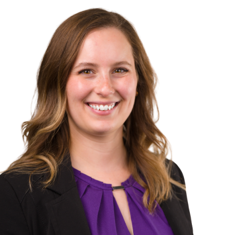 A woman wearing a purple shirt and black jacket